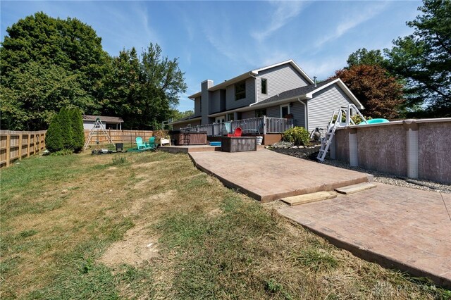 view of yard featuring a patio area and a wooden deck