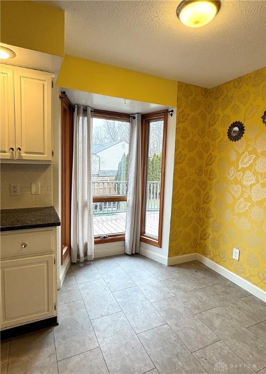 doorway featuring a textured ceiling and plenty of natural light