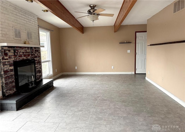 unfurnished living room with beamed ceiling, ceiling fan, and a brick fireplace