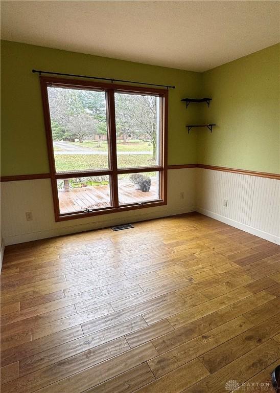 unfurnished room featuring hardwood / wood-style flooring