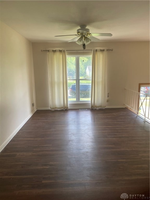 spare room featuring ceiling fan and dark hardwood / wood-style flooring