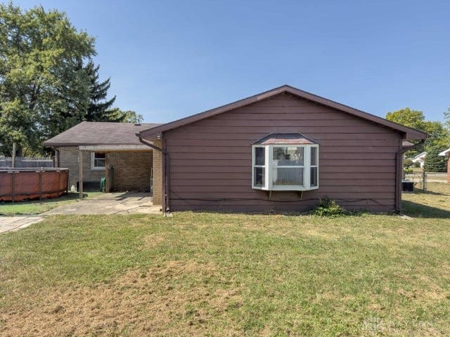 rear view of property featuring a yard