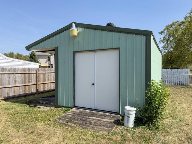 view of outbuilding with a yard