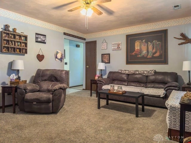 carpeted living room featuring ceiling fan