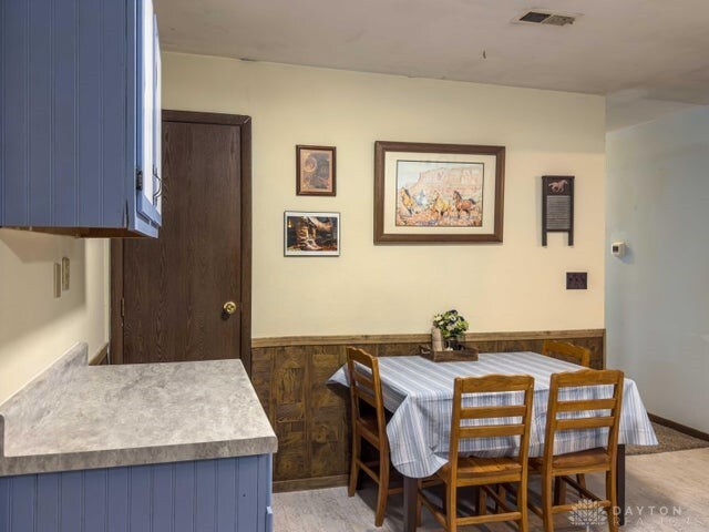 dining space with wood walls