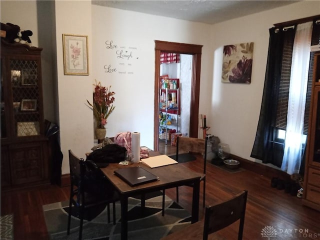 dining space with dark hardwood / wood-style floors