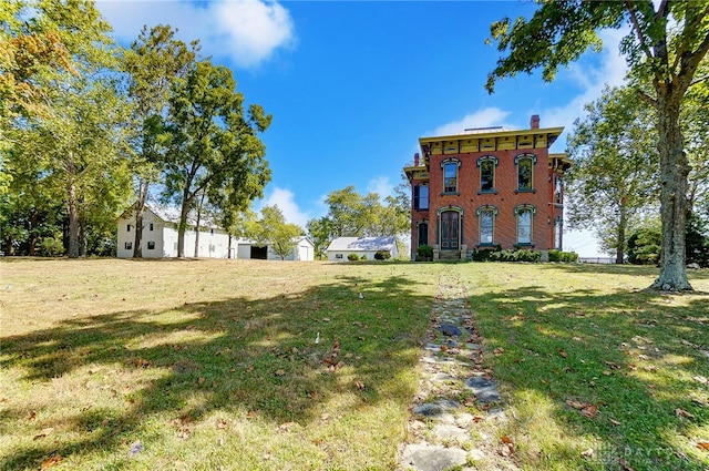 back of property with a lawn