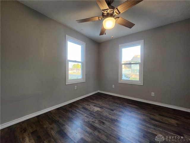 spare room featuring dark hardwood / wood-style floors and ceiling fan