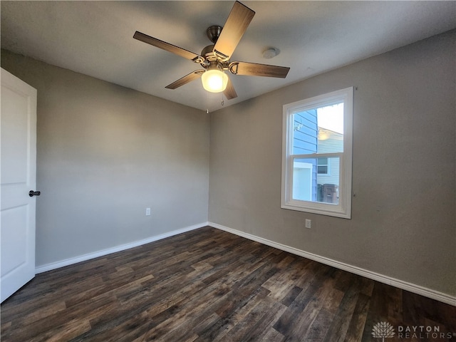 unfurnished room with dark hardwood / wood-style flooring and ceiling fan