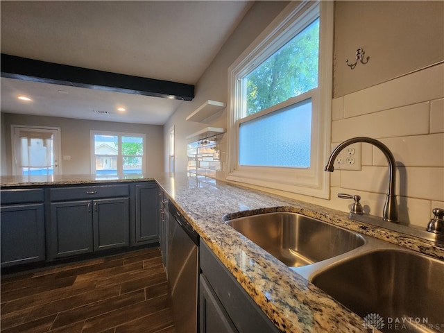 kitchen with beam ceiling, stainless steel dishwasher, a wealth of natural light, and sink