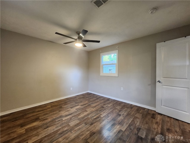 unfurnished room with ceiling fan and dark wood-type flooring