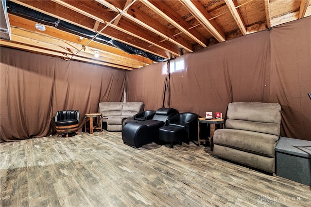 living area with wooden walls and hardwood / wood-style flooring