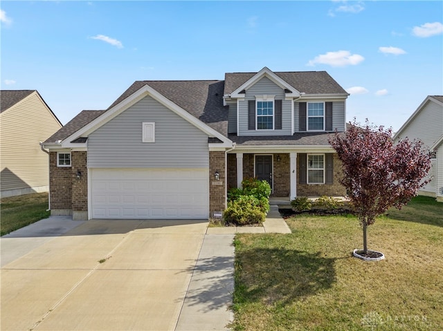 view of front of property with a front yard and a garage