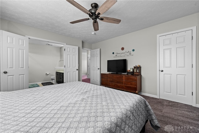 carpeted bedroom with ceiling fan, ensuite bathroom, and a textured ceiling