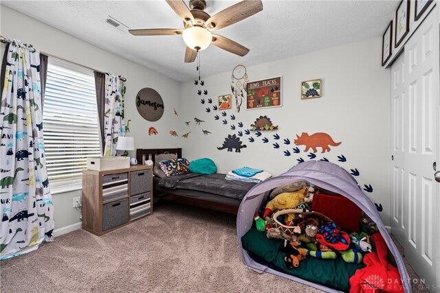 bedroom with ceiling fan, a closet, and carpet flooring