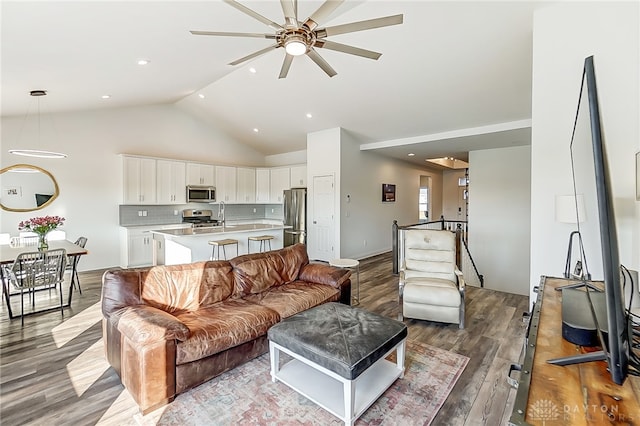 living room with high vaulted ceiling, sink, ceiling fan, and light hardwood / wood-style flooring