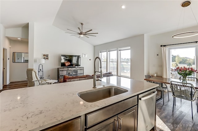 kitchen featuring light stone counters, ceiling fan, sink, decorative light fixtures, and dishwasher