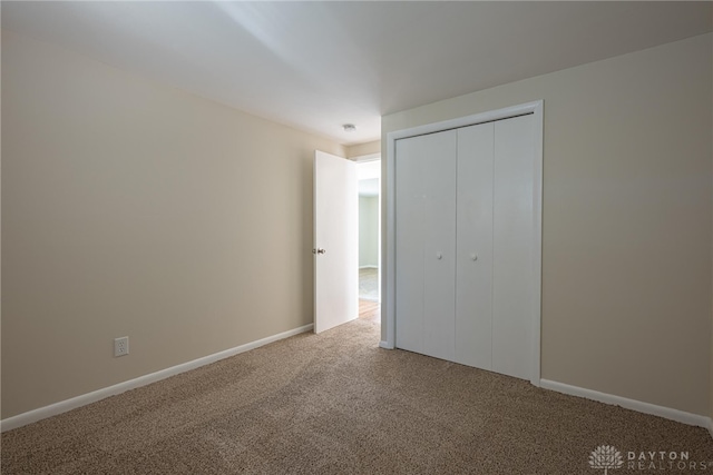 unfurnished bedroom featuring a closet and carpet flooring