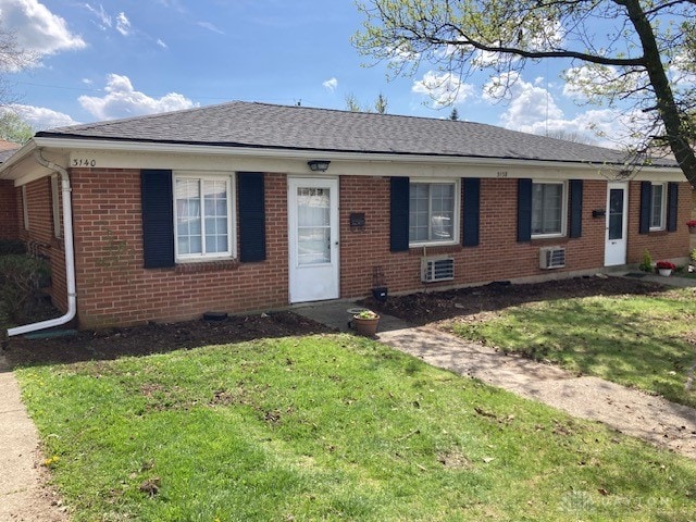 ranch-style home with a front lawn