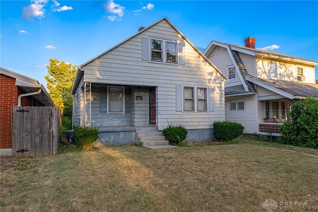 view of front of house featuring a front yard and central AC unit