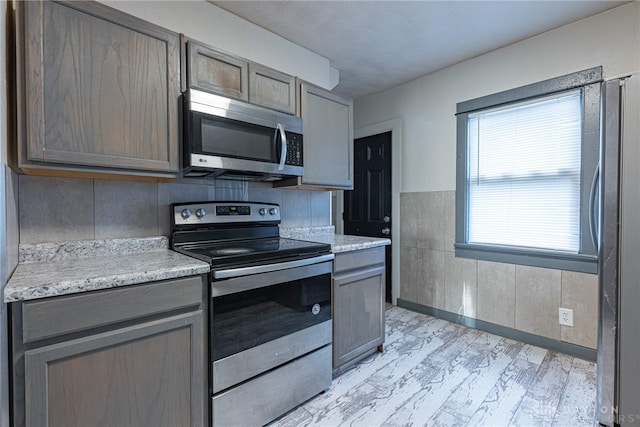 kitchen with stainless steel appliances and light hardwood / wood-style flooring