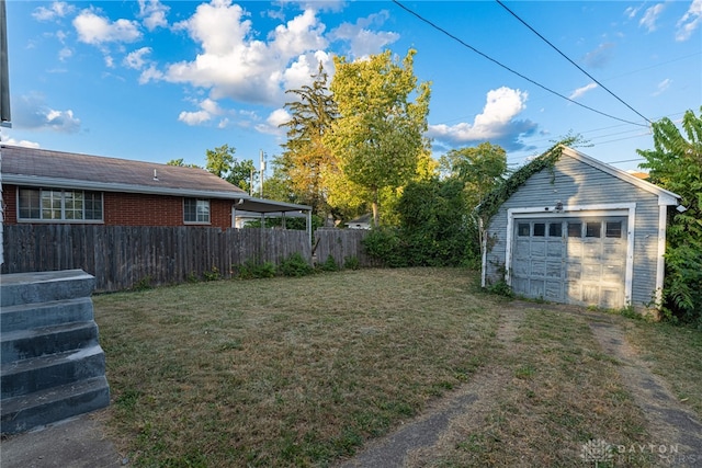 view of yard featuring an outdoor structure and a garage