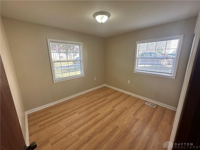 spare room featuring light wood-type flooring