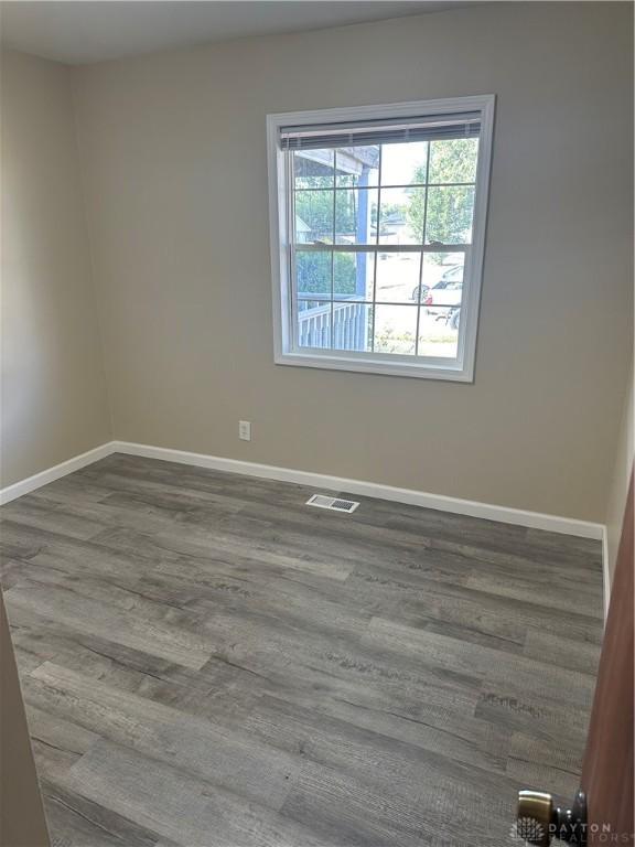 unfurnished room featuring wood-type flooring