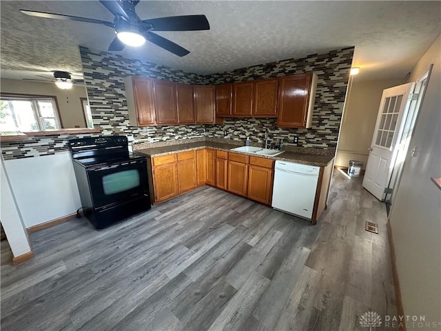 kitchen with sink, white dishwasher, a textured ceiling, black / electric stove, and decorative backsplash