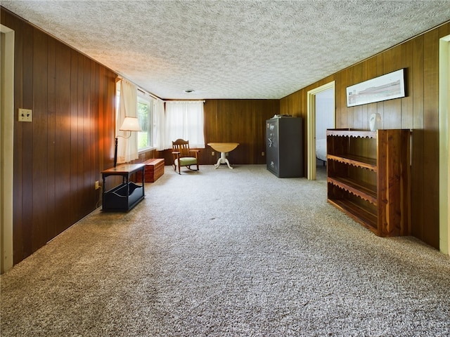 unfurnished room with a textured ceiling and carpet flooring