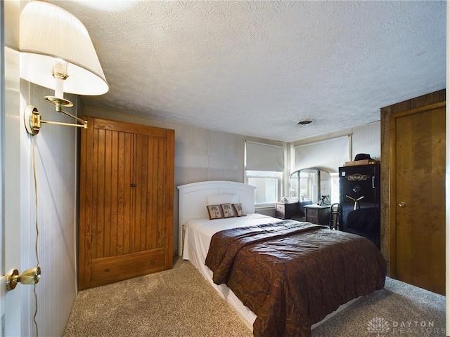 carpeted bedroom with a textured ceiling