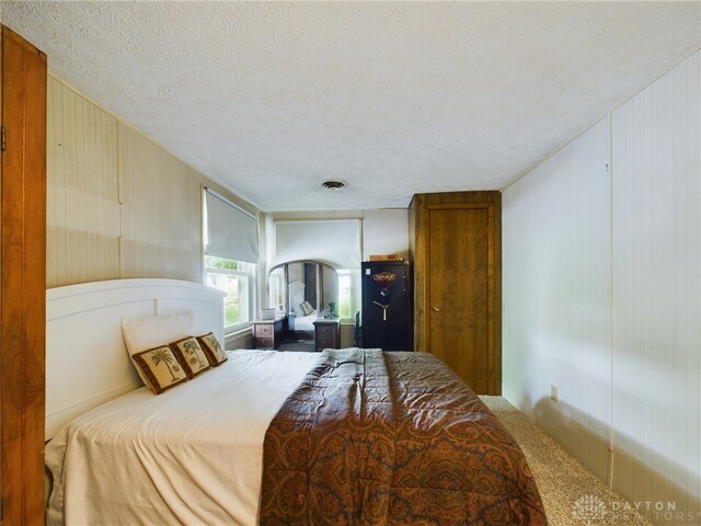 carpeted bedroom with a textured ceiling