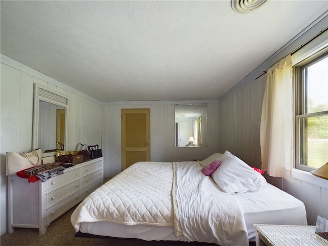 carpeted bedroom featuring a textured ceiling