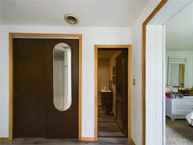 hallway with dark hardwood / wood-style flooring