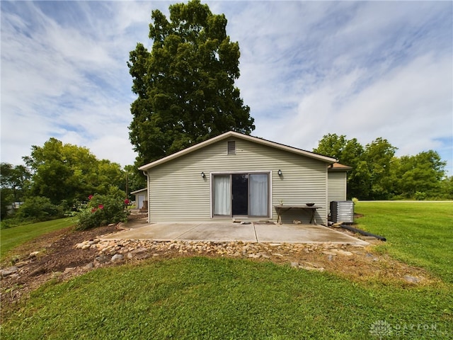 back of house with central AC, a yard, and a patio