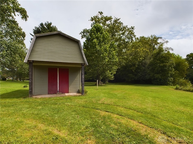 view of outdoor structure featuring a lawn