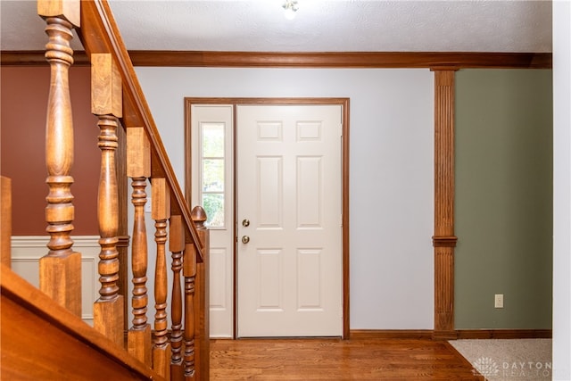 entryway with a textured ceiling and hardwood / wood-style flooring