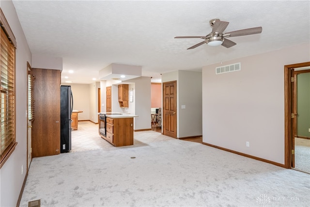 carpeted spare room with ceiling fan and a textured ceiling