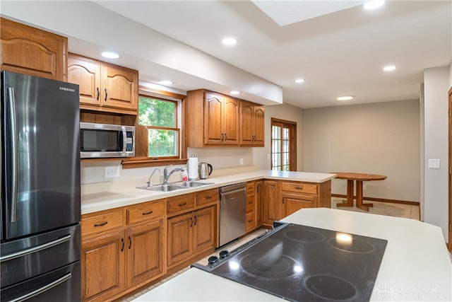 kitchen featuring kitchen peninsula, appliances with stainless steel finishes, and sink