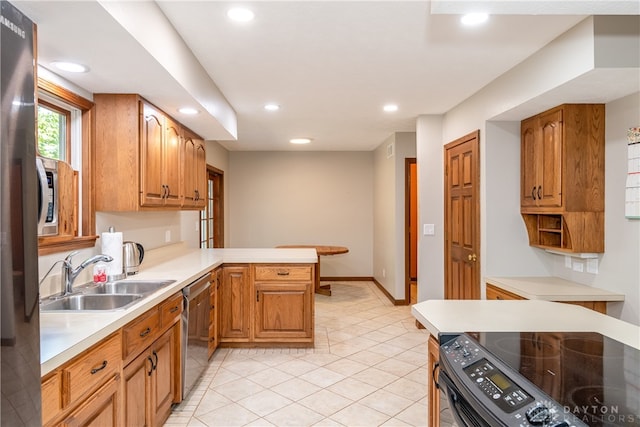 kitchen with stainless steel appliances, kitchen peninsula, light tile patterned floors, and sink