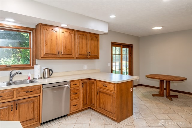 kitchen with dishwasher, plenty of natural light, kitchen peninsula, and sink