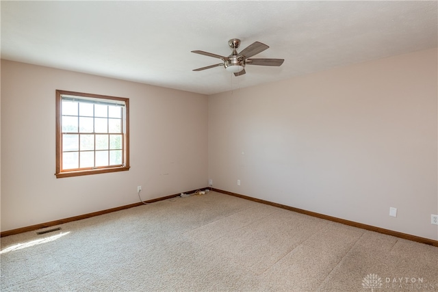 unfurnished room featuring ceiling fan and carpet flooring