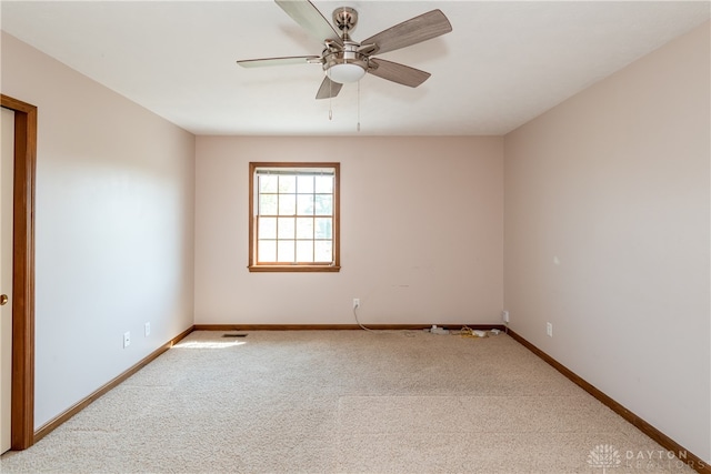 spare room with carpet and ceiling fan