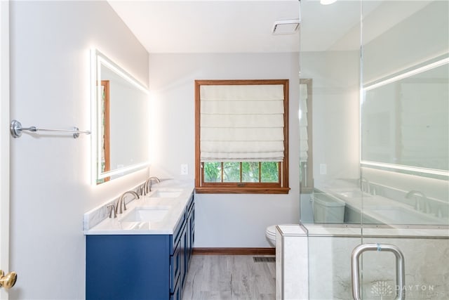 bathroom featuring vanity, hardwood / wood-style floors, and toilet