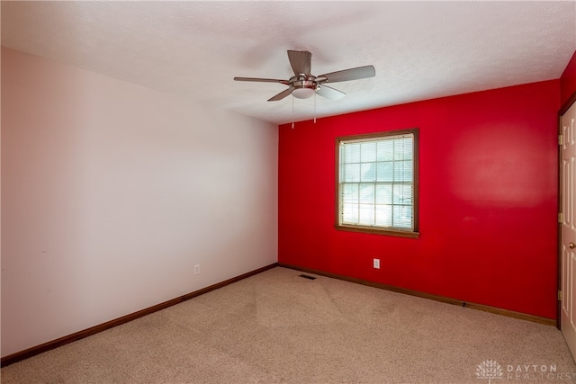 empty room featuring a textured ceiling and ceiling fan