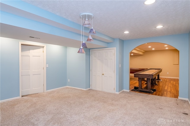 interior space with carpet floors and a textured ceiling