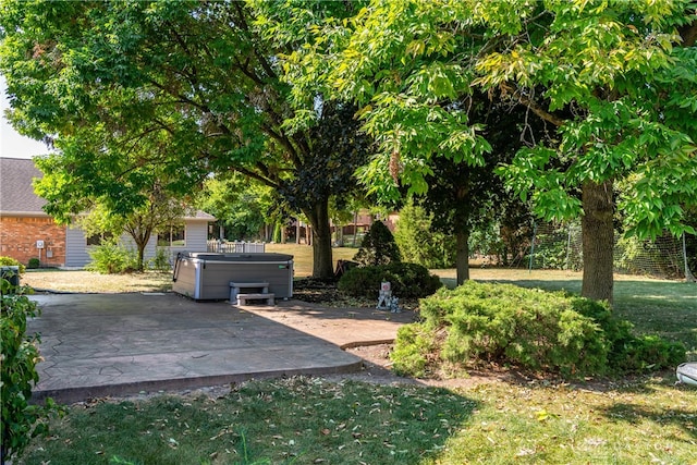 view of yard with a hot tub and a patio