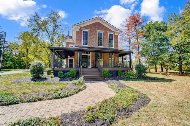 view of front facade with a front lawn and covered porch