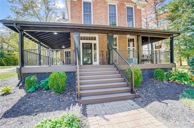 doorway to property featuring covered porch