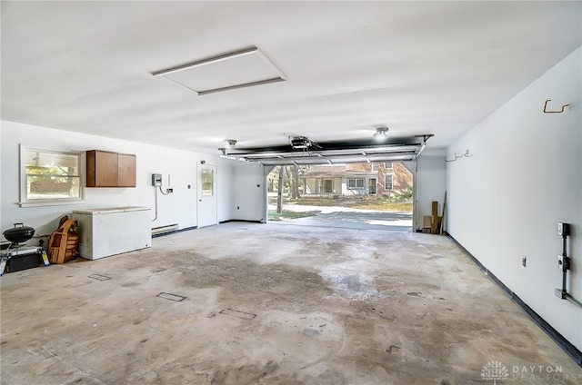 garage featuring fridge and a garage door opener